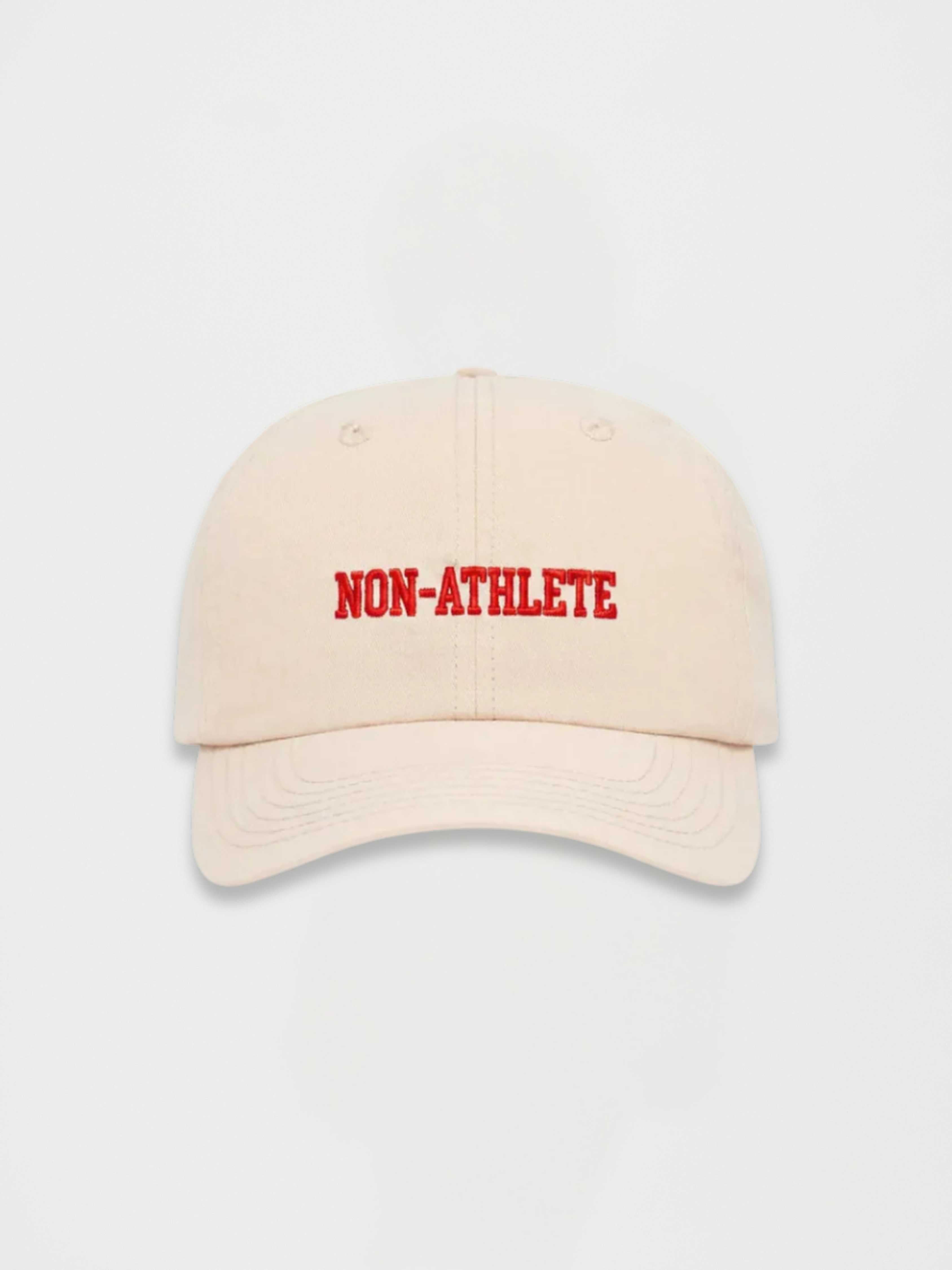 Non-Athlete ivory baseball cap with red embroidered logo