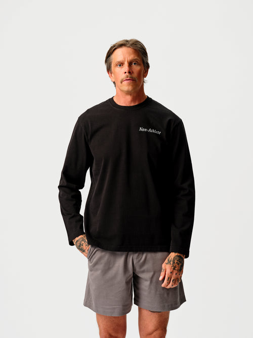 Model wearing the Black Long Sleeve T-Shirt by Non-Athlete